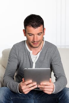 young man on sofa with a digital tablet