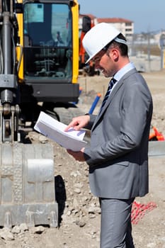 young man with hardhat on building site