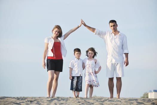 happy young family have fun and live healthy lifestyle on beach