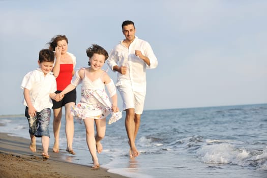 happy young family have fun and live healthy lifestyle on beach