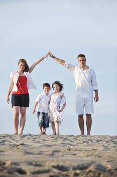 happy young family have fun and live healthy lifestyle on beach