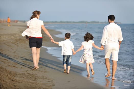 happy young family have fun and live healthy lifestyle on beach