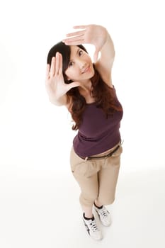 Asian beauty make a frame by hand and looking at you, full length portrait in studio white background.