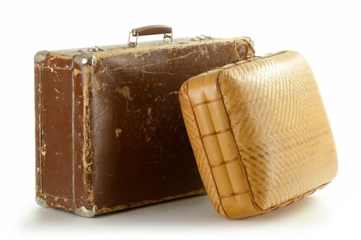 Two old travel suitcases isolated on white