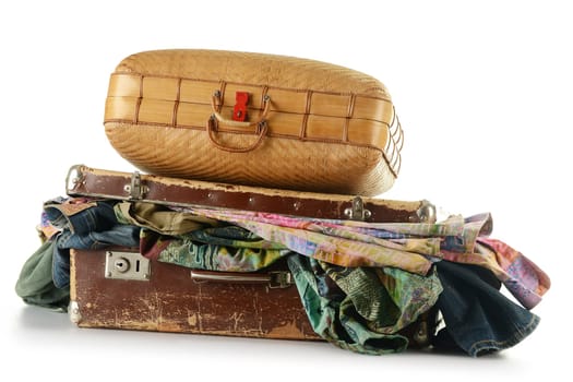 Two old travel suitcases isolated on white