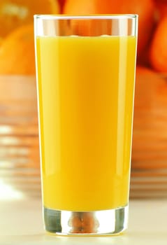 Composition with glass of orange juice and fruits