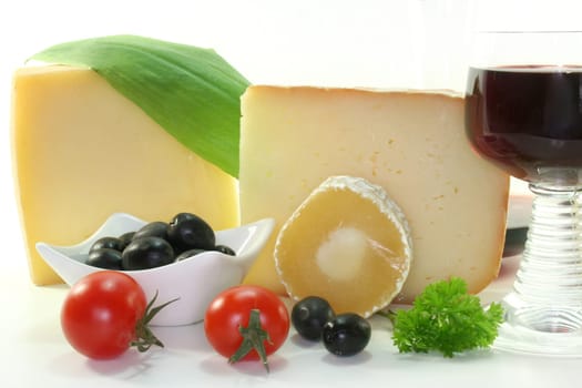 various cheeses and a glass of red wine