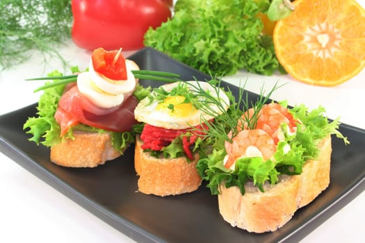 Various canapes against white background