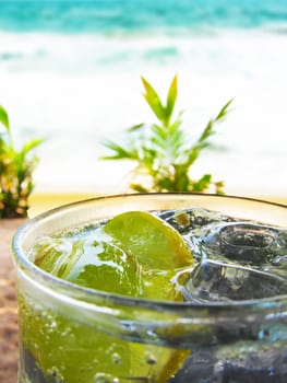 Refreshing lemon Soda With Ice At A Tropical Beach