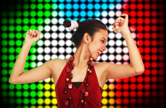 Beautiful Young Woman Dancing At A Club With Multicolored Spotlights Background