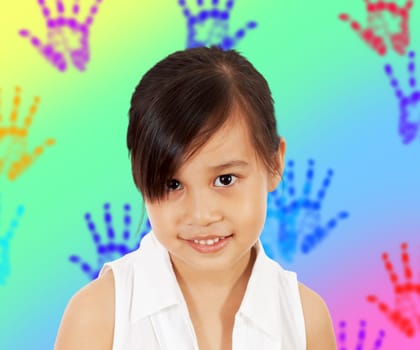 A Shy Young Girl In Her Play Room With Multicolored Hand Prints On The Wall