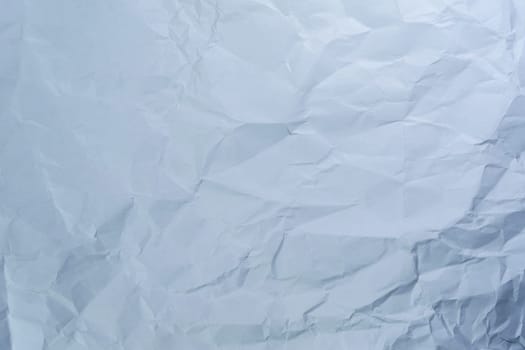 Crumpled white paper with detailed wrinkles and creases. Perfect for backgrounds, design templates, and texture overlays. Ideal for artistic and grunge-style projects