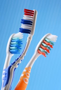 Composition with four toothbrushes on blue background