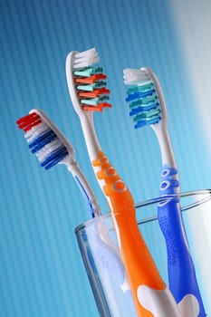 Composition with four toothbrushes on blue background