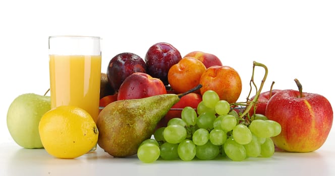 Composition with variety of fruits and glass of orange juice
