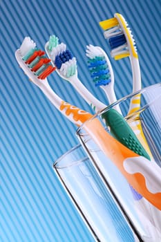 Composition with four toothbrushes on blue background