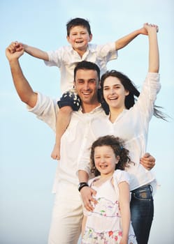 happy young family have fun and live healthy lifestyle on beach
