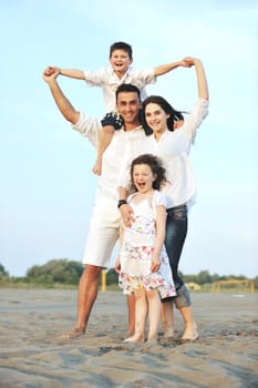 happy young family have fun and live healthy lifestyle on beach