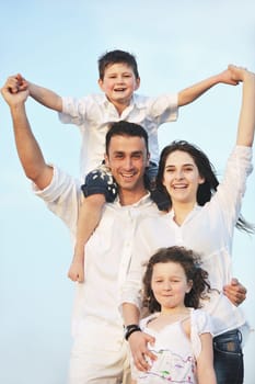 happy young family have fun and live healthy lifestyle on beach