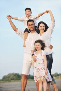 happy young family have fun and live healthy lifestyle on beach