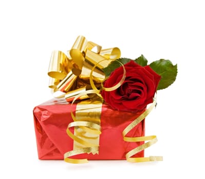 Festive gift with red rose and golden ribbons for the celebration of a special day. Isolated on white.