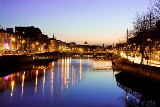 Dublin City at sunset - view over the river Liffey and historical Grattan bridge. Long exposure, tripod used.