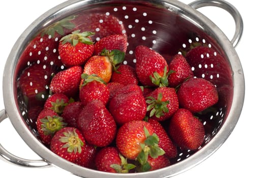 Shot of strawberries in strainer isolated on white