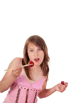 Teenager girl in studio eating strawberries isolated on white