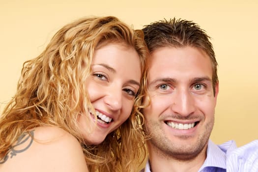 Portrait of a smiling young beautiful couple in love looking at camera.
