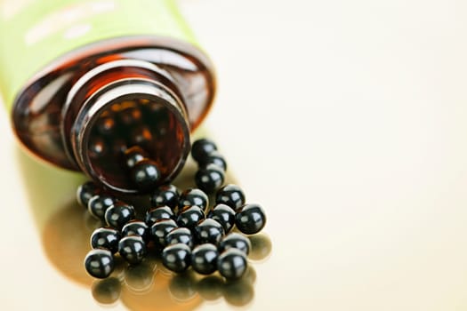 Traditional chinese herbal medicine pills spilling from bottle
