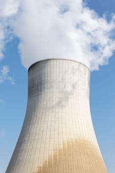 big smokestack of nuclear factory with blue sky