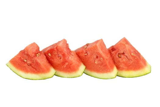 Four organic watermelon triangle slices upright side by side on white background.