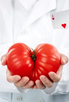 Researcher with the ace in his pocket holding a big sort of tomato