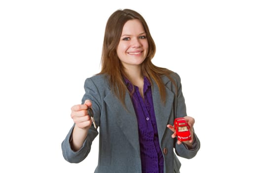 Young woman with model car and car key