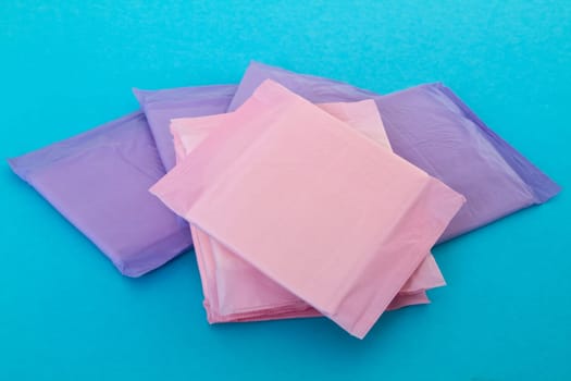 Several sanitary napkins on light blue background