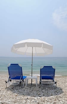Sunbeds and umbrella on the beach