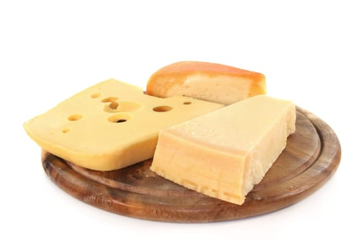 different types of cheese on a wooden board