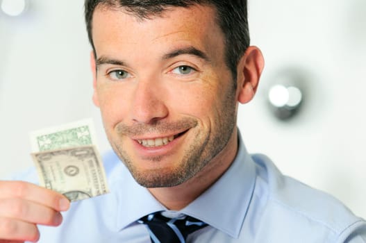 winner and cheerful businessman is showing a dollar