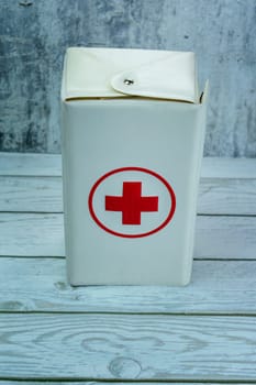A rectangular white case with a red cross symbol, typically used for first-aid supplies.