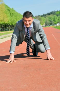 Portrait of a businessman on the starting blocks