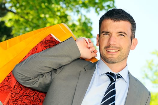 great businessman outdoor with colored shopping bags