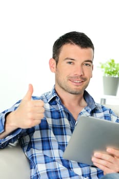 attractive relaxed and positive man is surfing on his