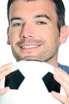 closeup of passionate soccer player with white and black balloon