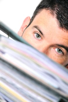 busy man hiding behind a stack of files