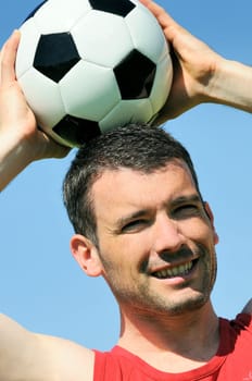 attractive football player with black and white balloon