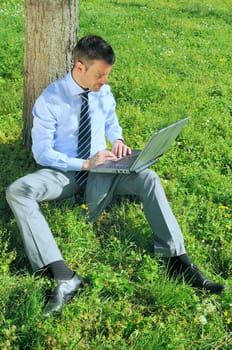 businessman is working in a natural background
