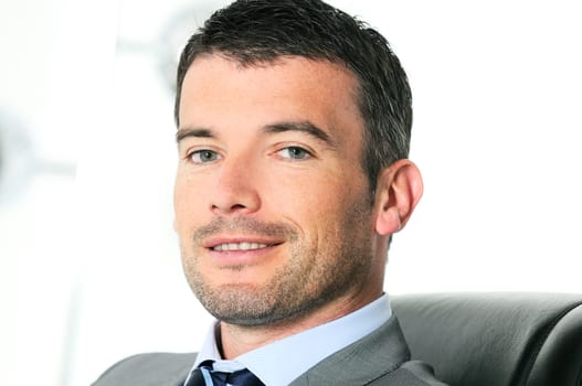 An attractive business man in a light business environment