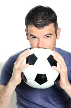 closeup of passionate soccer player with white and black balloon