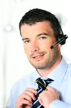 Young businessman with headset in office