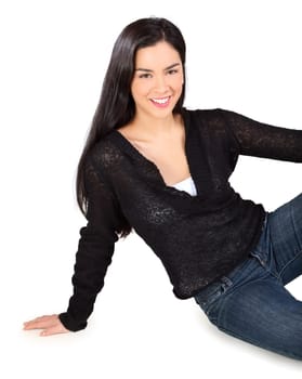 Beautiful smiling lady sitting on the floor and looking at the camera isolated on white.